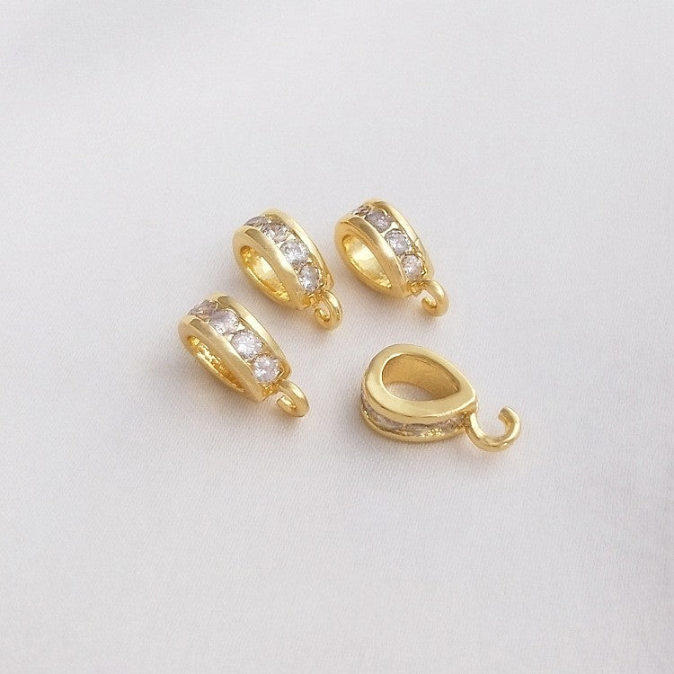 Fibbia ovale dorata con zircone