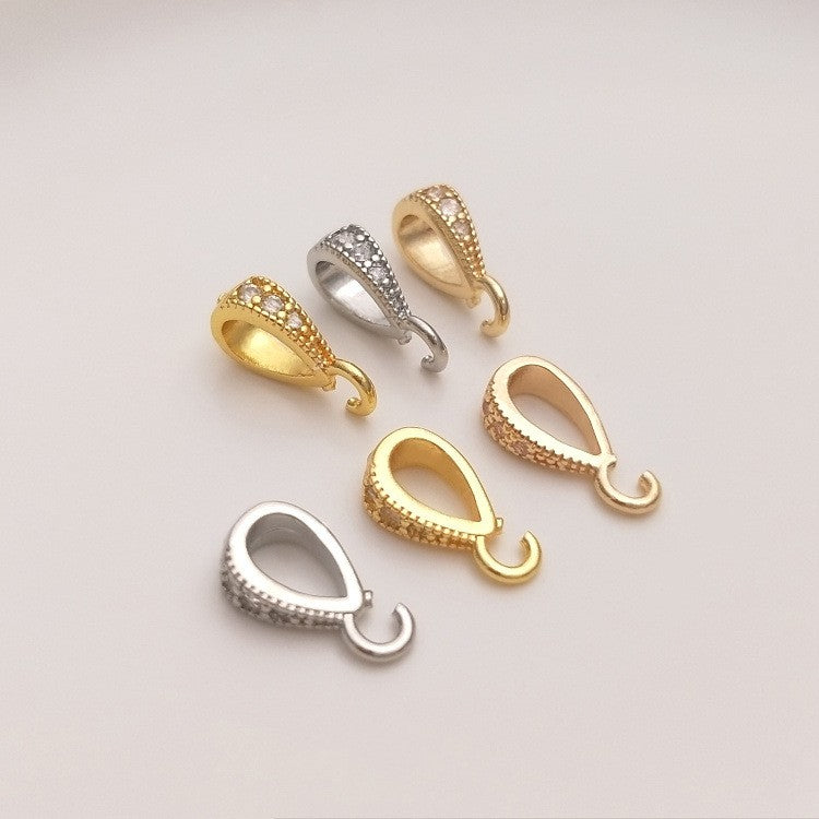 Fibbia ovale dorata con zircone