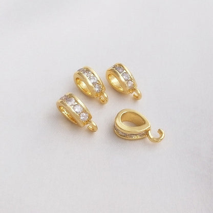 Fibbia ovale dorata con zircone