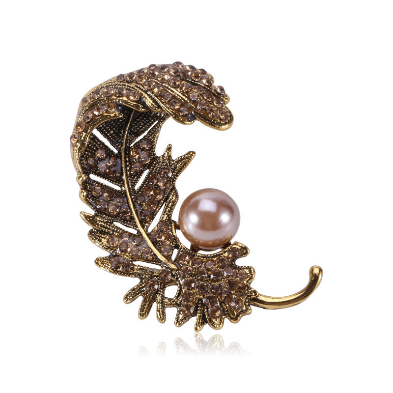 Spilla piuma con strass