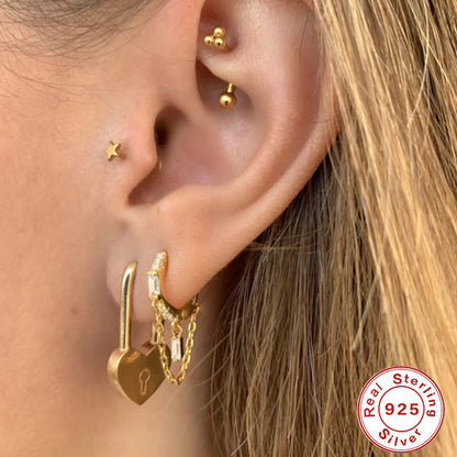 Orecchini geometrici zircone con nappina