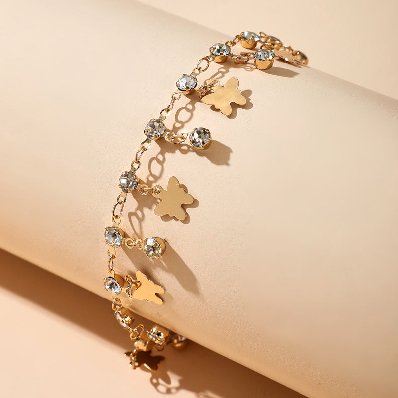 Cavigliera farfalla nappina con strass