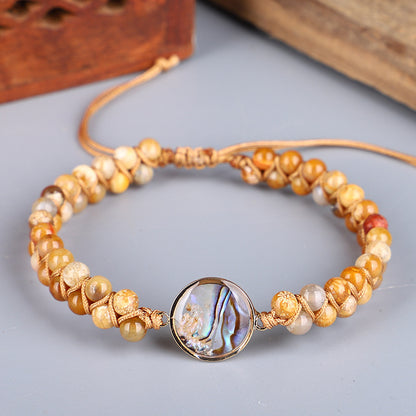Bracciale intrecciato conchiglia e pietre