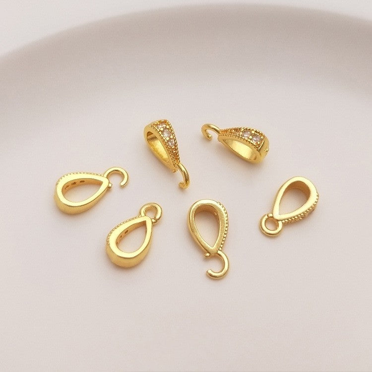 Fibbia ovale dorata con zircone