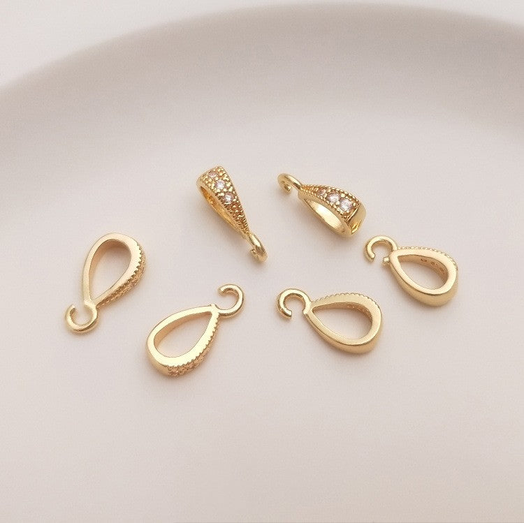 Fibbia ovale dorata con zircone