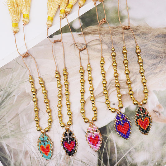 Bracciale tessuto cuore con nappina intrecciata